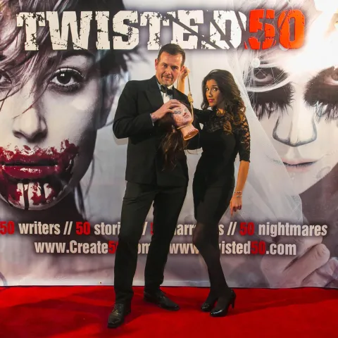 Three women posing for a photo on a red carpet.