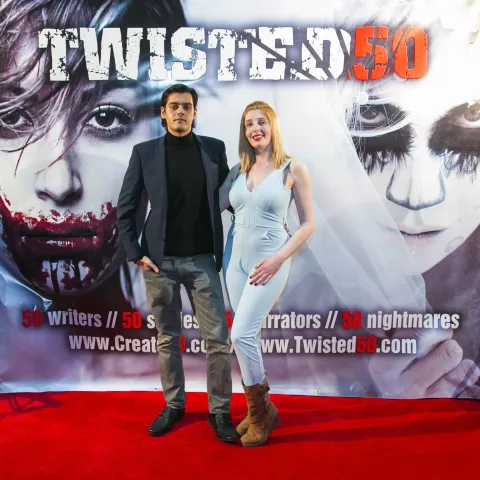 Two people standing on the red carpet at the twisted 50 premiere.