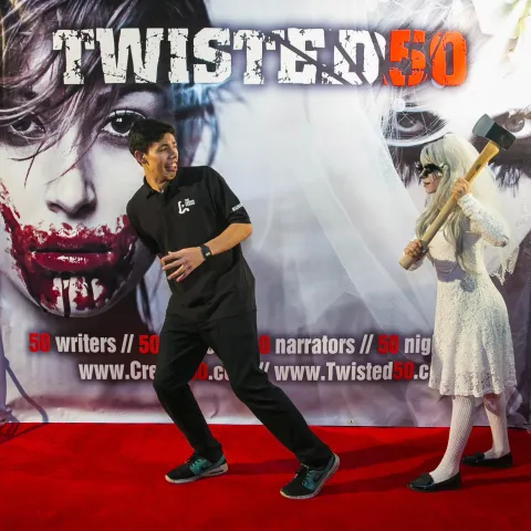 Three women posing for a photo on a red carpet.
