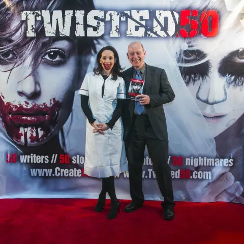 A man and woman posing for a photo at the twisted 50 premiere.