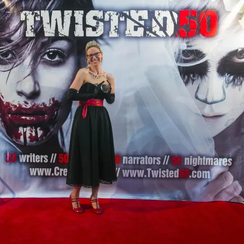 Two people standing on the red carpet at the twisted 50 premiere.