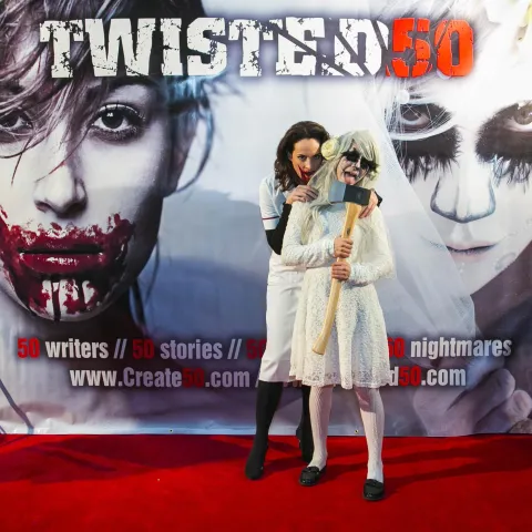 A man and woman posing for a photo at the twisted 50 premiere.
