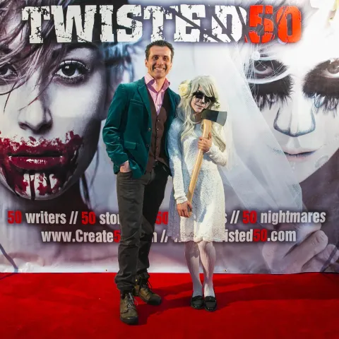 A man and woman posing for a photo at the twisted 50 premiere.