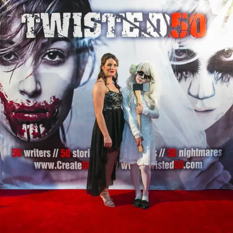 A man and woman posing for a photo at the twisted 50 premiere.