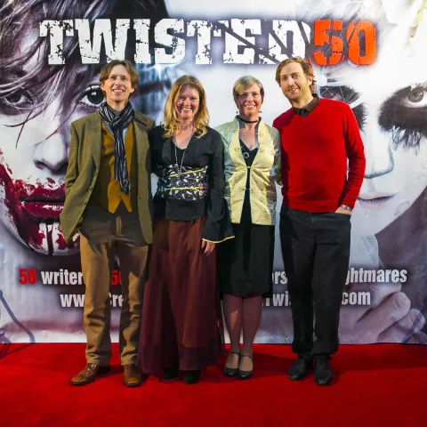 Two people standing on the red carpet at the twisted 50 premiere.