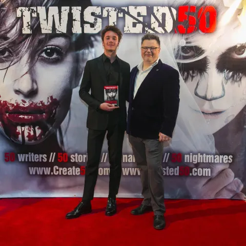 Two people standing on the red carpet at the twisted 50 premiere.