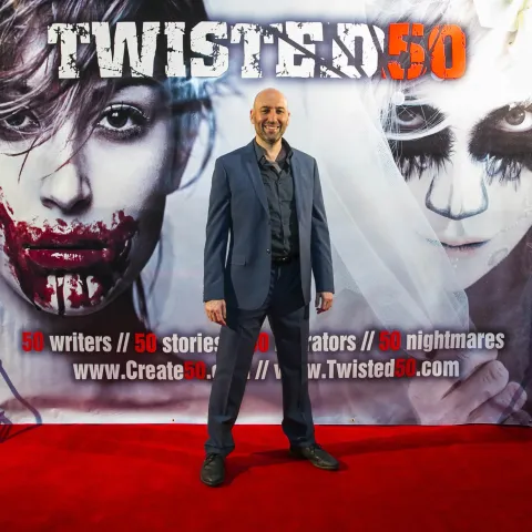 A group of people standing on a red carpet.