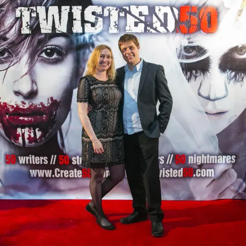 Three women posing for a photo on a red carpet.