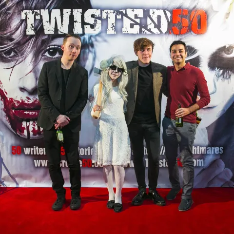 A man and woman posing for a photo at the twisted 50 premiere.