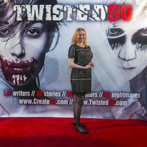 Two people standing on the red carpet at the twisted 50 premiere.