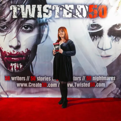 Three women posing for a photo on a red carpet.