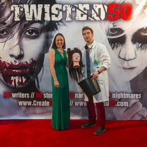 Three women posing for a photo on a red carpet.