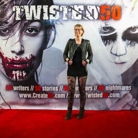 A man and woman posing on the red carpet for twisted 50.