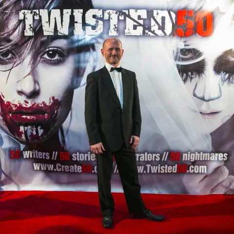 A woman and a girl standing next to a poster for twisted 50.