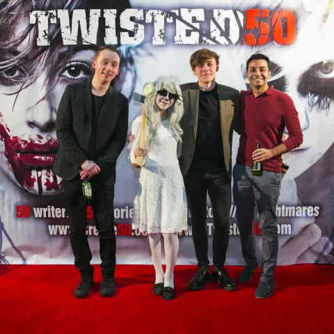 A man and woman posing for a photo at the twisted 50 premiere.
