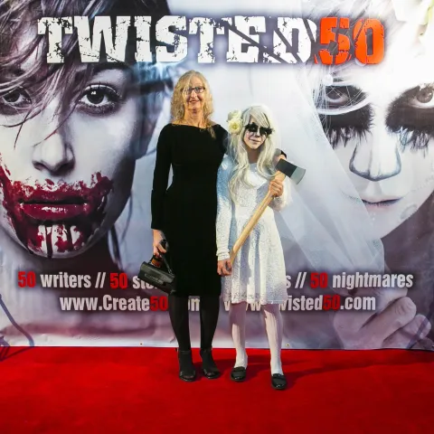 A group of people standing on a red carpet.