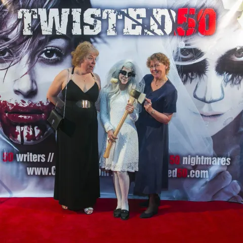 A man and woman posing for a photo at the twisted 50 premiere.